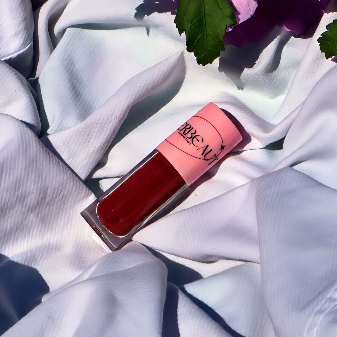 Scarlet Cocoa, high shine pigmented tinting nude gloss, in a pink-capped MEERBEAUT wand tube